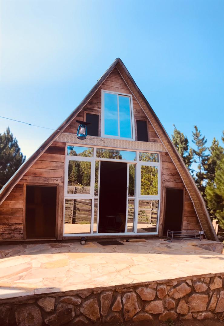 A-frame glamping hut at Kyenwa Homestay under an open sky